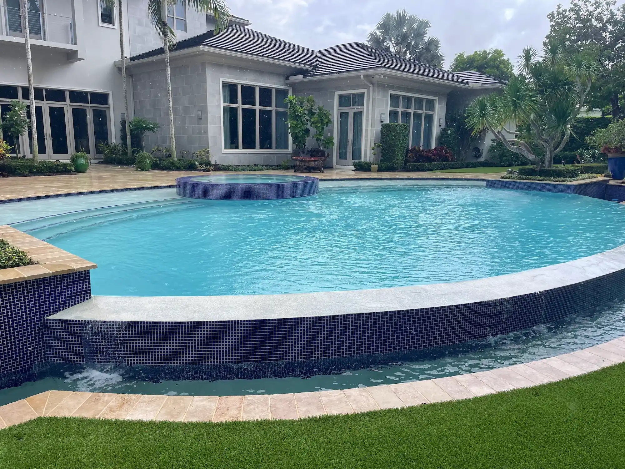 Palm Beach Pool team restoring damaged tiles around residential swimming pool.