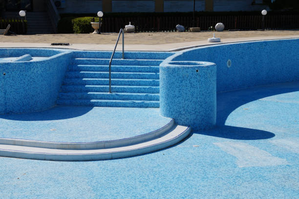 Technicians applying new pool surface coating for smooth durable results<br />
