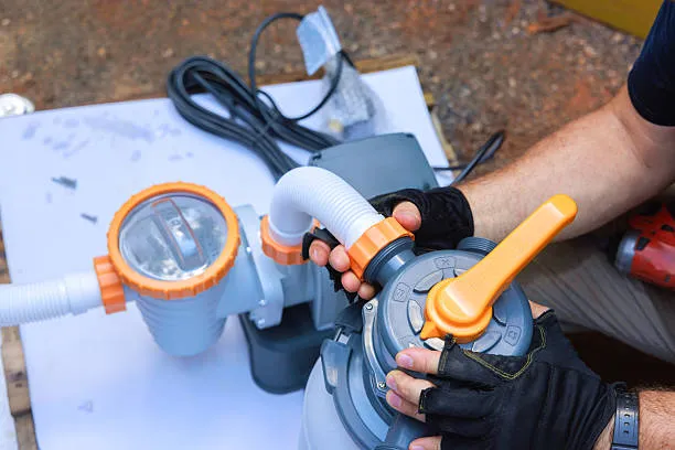 Technician checking a pool salt system and sensor components in Royal Palm Beach, FL. Pool Equipment repair near me